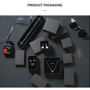 Minimalist black matte jewelry boxes for rings and necklaces with elegant props