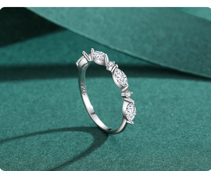 Macro shot of S925 sterling silver ring showing marquise-cut stones and inner hallmark
