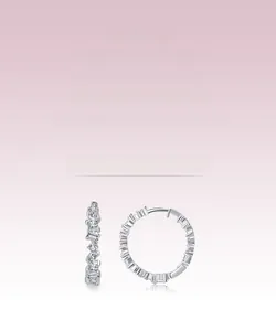 Detailed macro view of S925 silver hoop earrings with irregular zircon stones and bright shine