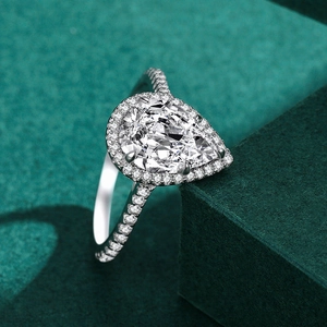 Luxurious S925 silver halo ring with a pear-cut 3-carat diamond on a green jewelry box