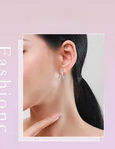 Close-up of a model wearing sparkling s925 silver hoop earrings with irregular zircons
