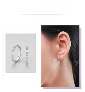 Macro detail of S925 sterling silver hoop earrings with white zircon stones and S925 stamp
