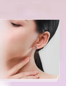 Macro view of S925 silver crescent moon stud earrings with micro-inlaid cubic zirconia