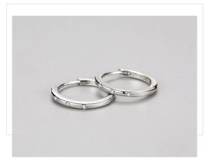 Macro detail of S925 sterling silver hoop earrings featuring micro-set white zircon stones