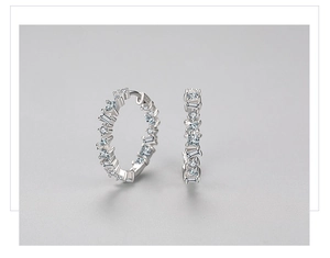 Close-up of S925 silver stamp on hoop earrings with inlaid clear zircon stones
