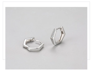 Macro shot of hexagonal silver huggie earrings with pavé set cubic zirconia stones
