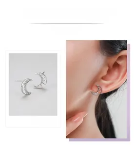 Macro detail of silver moon stud earrings featuring hollow design and sparkling zircon pavé