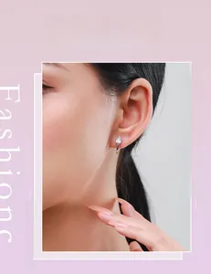 Close-up of model wearing s925 silver teardrop earrings with sparkling pear-cut crystals