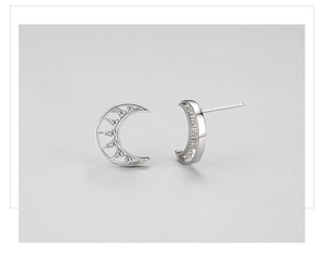 Macro detail of crescent moon S925 silver stud earrings with micro-set cubic zirconia