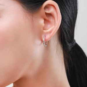 Elegant S925 sterling silver hoop earrings with micro-pave cubic zirconia on a model