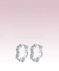 Macro shot of silver-toned wave hoops with marquise-cut marquise stones in a snug set design