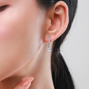 S925 sterling silver drop earrings with round simulated diamonds on model in side view