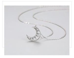 Macro view of S925 sterling silver moon pendant with micro-inlaid cubic zirconia stones