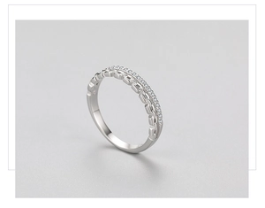 Detail of S925 silver double-layered ring with Cuban link chain and pave-set zircons
