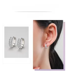 Detail view of S925 sterling silver hoop earrings with rectangular zircon on model