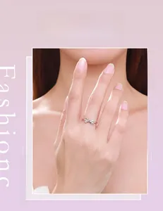 Close-up of s925 silver bow ring with micro-pave diamonds on a female finger