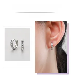 Close-up and ear model shot of S925 sterling silver huggie earrings with cubic zirconia