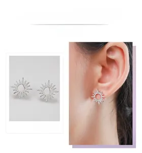 Macro detail of S925 sterling silver sunflower stud earrings with pavé set crystals