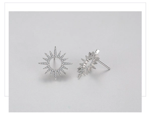 Macro detail of S925 sterling silver sunflower stud earrings with pavé zircon stones