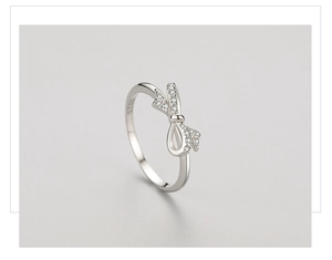 Macro detail of S925 sterling silver bow ring with shimmering micro-pave crystals