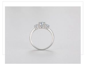 Close-up of a 925 sterling silver three-stone ring with sparkling round cubic zirconia