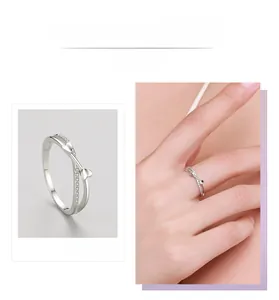 Detail display of silver double layer crisscross ring with zircons and tiny hearts