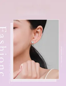 Close-up of minimalist S925 sterling silver micro-pave round stud earrings on a female model