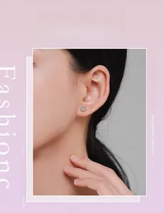 Model wearing a minimalist S925 sterling silver three-petal clover stud earring with zircons