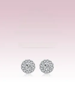 Macro detail of S925 sterling silver halo stud earrings with brilliant pavé crystals