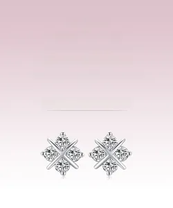 Close-up detail of cross-shaped s925 silver stud earrings with clear round zircons