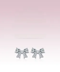 Detail of s925 silver bow earrings featuring pavé setting and teardrop zircon crystals