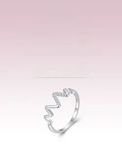 Detailed close-up of S925 sterling silver stamp on wave ring with pavé-set diamonds