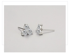 Macro shot of S925 sterling silver stud earrings featuring three brilliant round diamonds