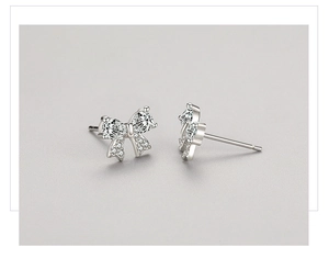 Detailed view of S925 sterling silver bow earrings with sparkling cubic zirconia stones