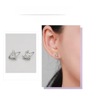 Detail of geometric triangle S925 silver stud earrings with sparkling cubic zirconia stone