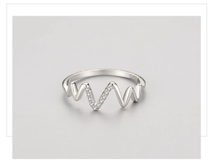 Macro detail of wave-shaped S925 silver ring with sparkling micro-pave cubic zirconia