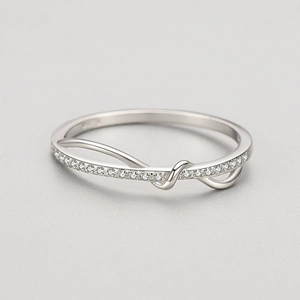 Elegant S925 sterling silver interlaced ring with micro-pave crystals on a grey background
