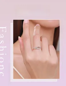Model wearing a minimalist S925 silver criss-cross ring with micro-pave cubic zirconia