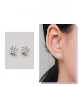 Detail display of silver snowflake stud earrings inlaid with clear cubic zirconia crystals