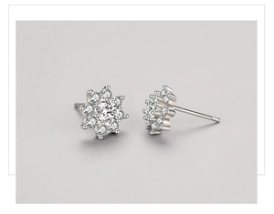 Detail of flower stud earrings featuring micro-paved cubic zirconia in S925 silver finish