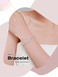 Detail of S-shaped silver bracelet with shimmering pavé-set zircon on model wrist