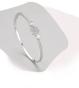 Detailed macro view of S925 silver four-leaf clover bangle with pink waterdrop gemstone