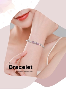Macro detail of silver rose flower bracelet with pink zircon stones on female wrist