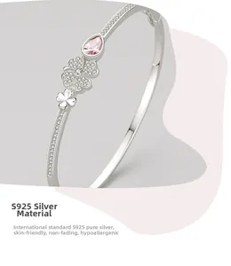 Detail of S925 sterling silver four-leaf clover bangle with pink teardrop crystal