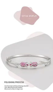 Macro detail of silver rose bracelet featuring pink crystals and polished textures