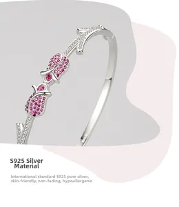 Macro shot of S925 silver tulip bangle with pink zircon stones and detailed engraving