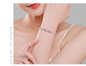 Macro detail of silver rose bracelet featuring pink pavé crystals and branch texture