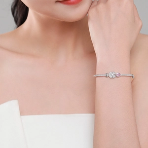 Elegant S925 sterling silver four-leaf clover bracelet with pink gemstone on wrist