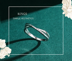 Macro shot of silver S925 cross ring with micro-pave zircons on a dark green background