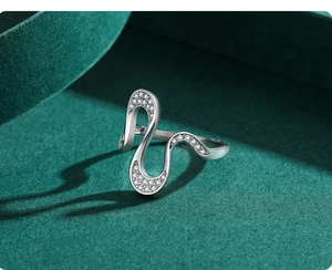 Macro view of silver S925 geometric wavy ring with micro-pave cubic zirconia stones